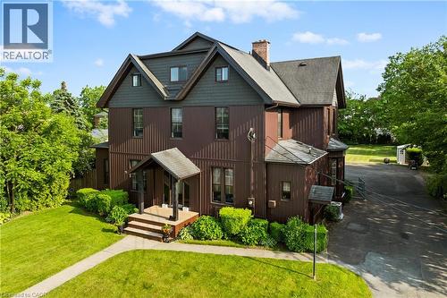 View of front of home with a chimney, a front lawn, a shingled roof, and driveway - 5368 Menzie Street, Niagara Falls, ON - Outdoor