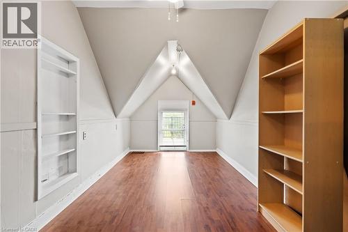 Bonus room with wood finished floors, built in features, vaulted ceiling, and a ceiling fan - 5368 Menzie Street, Niagara Falls, ON - Indoor Photo Showing Other Room