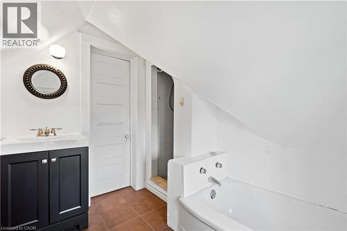 Full bathroom featuring vaulted ceiling, a bath, vanity, tile patterned flooring, and tiled shower - 5368 Menzie Street, Niagara Falls, ON - Indoor Photo Showing Bathroom