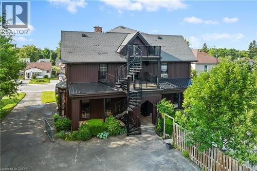 View of front of home with stairway, a shingled roof, a chimney, a metal roof, and a deck - 5368 Menzie Street, Niagara Falls, ON - Outdoor