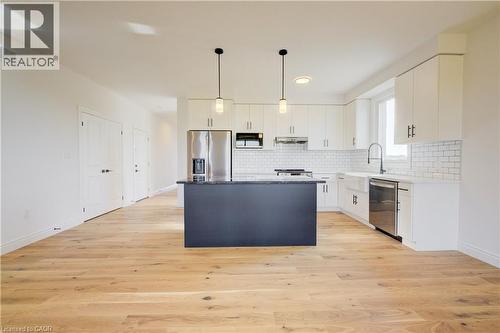 Upgraded colour on the kitchen island - 117 Thackeray Way, Harriston, ON - Indoor Photo Showing Kitchen With Upgraded Kitchen