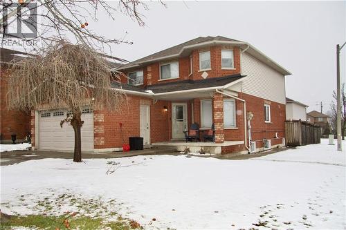 Snow covered back of property with a porch and brick siding - 3 Jacqueline Boulevard, Hamilton, ON - Outdoor