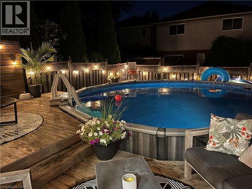 Pool at twilight with a deck and an outdoor pool - 3 Jacqueline Boulevard, Hamilton, ON - Outdoor With Above Ground Pool