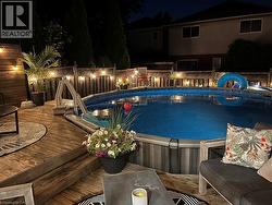 Pool at twilight with a deck and an outdoor pool - 
