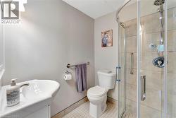 Full bath with vanity, tile patterned floors, and a stall shower - 
