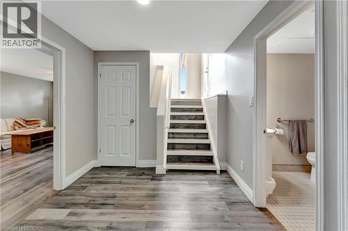 Stairs featuring wood finished floors and baseboards - 1565 Old Brock Street, Vittoria, ON - Indoor Photo Showing Other Room