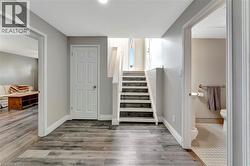 Stairs featuring wood finished floors and baseboards - 