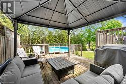 Wooden deck with an outdoor living space and a grill - 