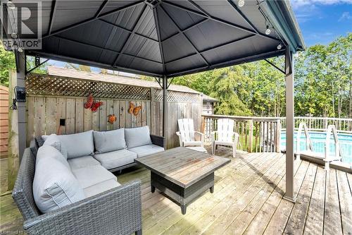 Wooden terrace with a fenced backyard, an outdoor living space, a gazebo, and view of wooded area - 1565 Old Brock Street, Vittoria, ON - Outdoor With Above Ground Pool With Deck Patio Veranda With Exterior