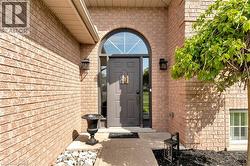 View of exterior entry featuring brick siding - 