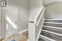 Staircase featuring baseboards and tile patterned floors - 