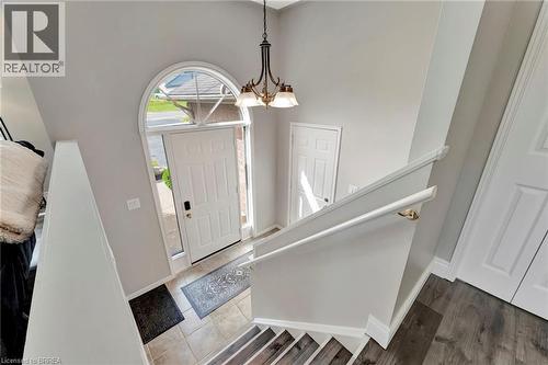Foyer entrance featuring a chandelier, stairs, and a towering ceiling - 1565 Old Brock Street, Vittoria, ON - Indoor Photo Showing Other Room