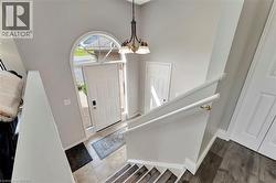 Foyer entrance featuring a chandelier, stairs, and a towering ceiling - 
