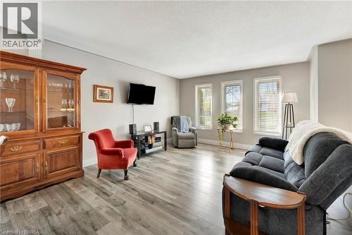 Living room featuring light wood-type flooring and a textured ceiling - 1565 Old Brock Street, Vittoria, ON - Indoor Photo Showing Living Room