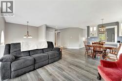 Living area featuring a chandelier and wood finished floors - 