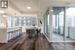 Dining area featuring a tray ceiling and dark wood finished floors - 