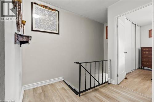 Hallway featuring an upstairs landing and light wood-style floors - 350 Quigley Road Unit# 512, Hamilton, ON - Indoor Photo Showing Other Room
