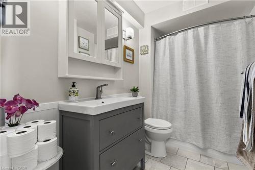 Bathroom with vanity, light tile patterned floors, and shower - 350 Quigley Road Unit# 512, Hamilton, ON - Indoor Photo Showing Bathroom