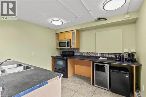Party Room Kitchen - 350 Quigley Road Unit# 512, Hamilton, ON - Indoor Photo Showing Kitchen With Double Sink