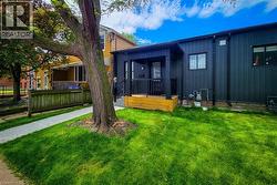 Back of property with board and batten siding and a yard - 