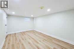 Below grade area with recessed lighting and light wood-style floors - 