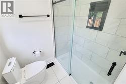 Full bath featuring a stall shower and tile patterned flooring - 