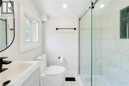 Bathroom featuring vanity, a stall shower, tile patterned flooring, and recessed lighting - 51 West Avenue N, Hamilton, ON - Indoor Photo Showing Bathroom