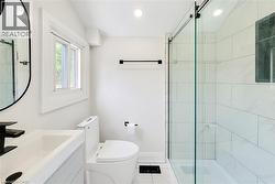 Bathroom featuring vanity, a stall shower, tile patterned flooring, and recessed lighting - 