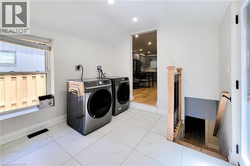 Washroom with vaulted ceiling, washer and dryer, tile patterned flooring, and recessed lighting - 51 West Avenue N, Hamilton, ON - Indoor Photo Showing Laundry Room