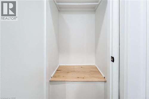 Walk in closet featuring light wood-style flooring - 51 West Avenue N, Hamilton, ON - Indoor Photo Showing Other Room