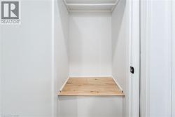 Walk in closet featuring light wood-style flooring - 