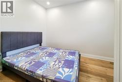 Bedroom featuring wood finished floors and recessed lighting - 