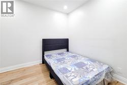 Bedroom featuring light wood finished floors and recessed lighting - 