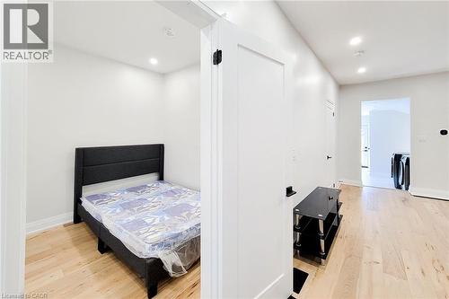 Bedroom with light wood-style floors and recessed lighting - 51 West Avenue N, Hamilton, ON - Indoor