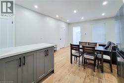 Dining space with recessed lighting and light wood-style floors - 