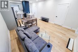 Living area featuring light wood-style flooring and recessed lighting - 