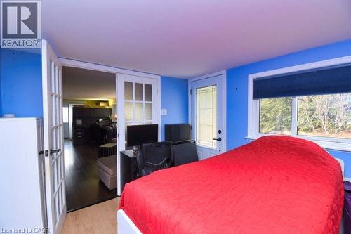 Bedroom featuring a desk, light wood-type flooring, and french doors - 1085 10Th Concession Road W Unit# 77, Flamborough, ON - Indoor Photo Showing Bedroom