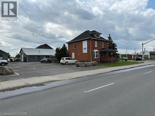 View of asphalt road featuring sidewalks, curbs, and street lighting - 1360 E Rymal Road E, Hamilton, ON 