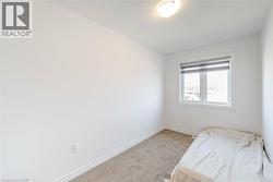 Unfurnished bedroom with carpet floors and baseboards - 