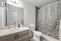 Full bath featuring a shower stall, vanity, and tile patterned floors - 