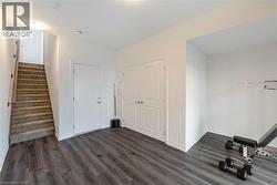 Workout room featuring dark wood-style flooring - 