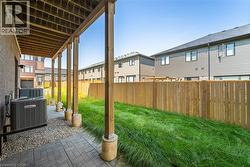 Fenced backyard featuring a patio area and a residential view - 