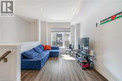 Living room with wood finished floors and recessed lighting - 