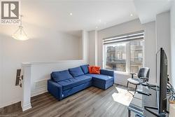 Living room featuring wood finished floors and recessed lighting - 