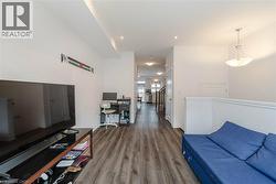 Living area with dark wood-style floors and recessed lighting - 
