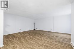 Spare room featuring light wood-type flooring and baseboard heating - 