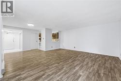 Unfurnished living room with wood finished floors and a textured ceiling - 