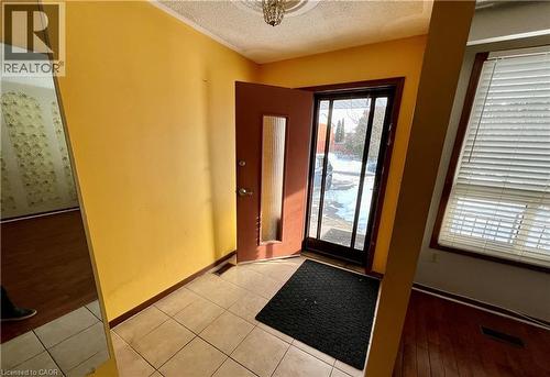 Foyer with a textured ceiling and light tile patterned floors - 185 Lavina Crescent, Hamilton, ON - Indoor Photo Showing Other Room