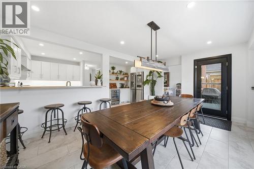 Dining room with recessed lighting, wine cooler, and light tile patterned floors - 136 Braemar Avenue, Caledonia, ON - Indoor Photo Showing Dining Room