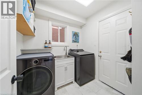 Laundry room with washer and dryer and a sink - 136 Braemar Avenue, Caledonia, ON - Indoor Photo Showing Laundry Room